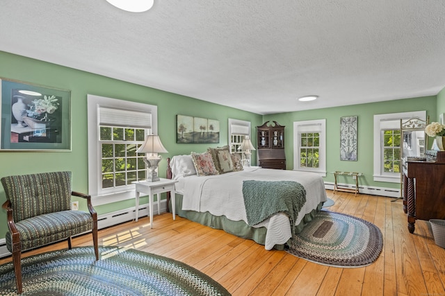 57 NW Corner Rd, Preston, CT 06365 - bedroom featuring a baseboard radiator, hardwood / wood-style flooring, and a textured ceiling