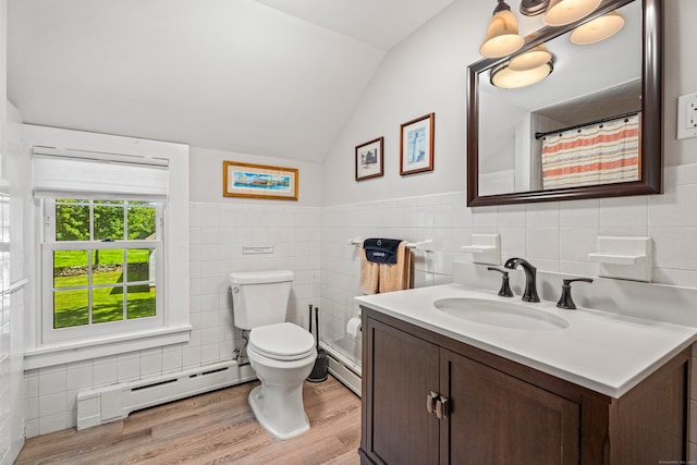 bathroom featuring tile walls, a baseboard heating unit, lofted ceiling, and toilet