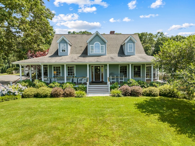 cape cod home with a porch and a front lawn