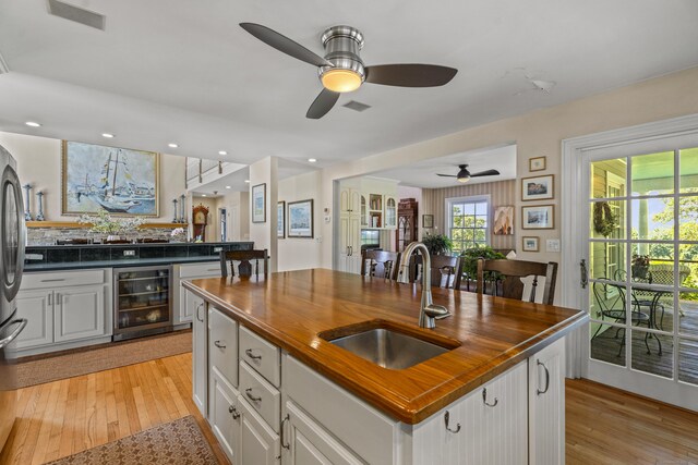 57 NW Corner Rd, Preston, CT 06365 - kitchen featuring a ceiling fan, wooden counters, a sink, light wood finished floors, and wine cooler