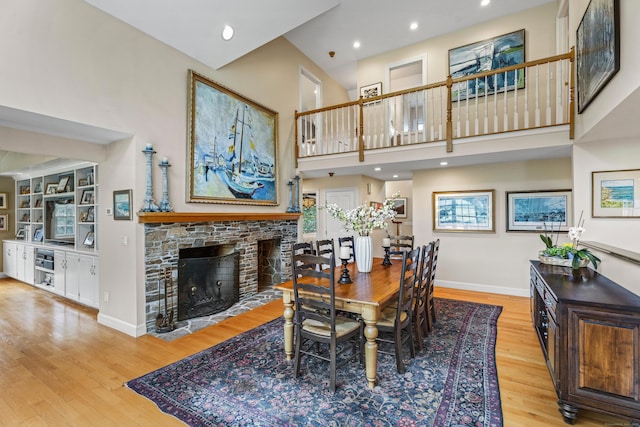 57 NW Corner Rd, Preston, CT 06365 - dining room with baseboards, a towering ceiling, wood finished floors, and a fireplace