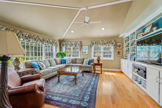 living room featuring ceiling fan, lofted ceiling, and light wood-type flooring