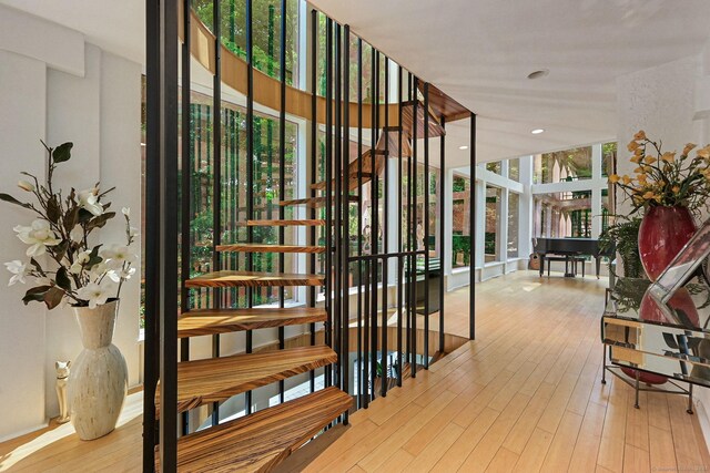 interior space with plenty of natural light and hardwood / wood-style floors