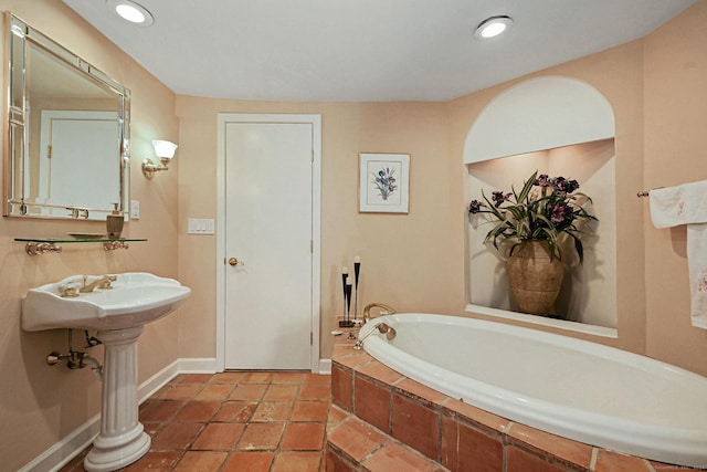 full bathroom featuring recessed lighting, baseboards, and a bath