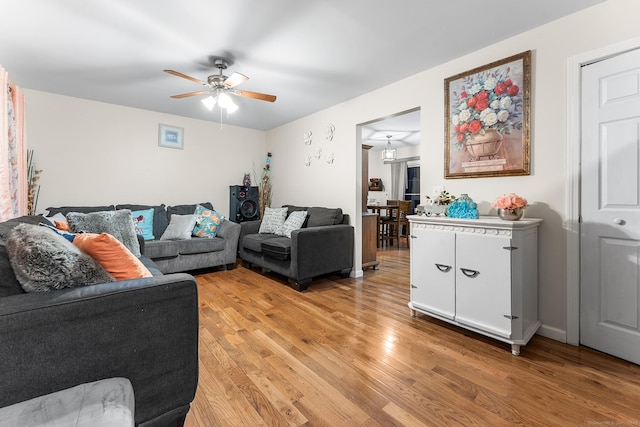 living room featuring ceiling fan and light hardwood / wood-style flooring