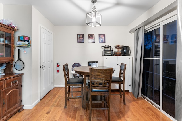 dining space with light hardwood / wood-style floors