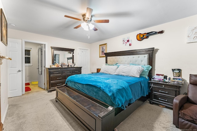 bedroom featuring light colored carpet and ceiling fan