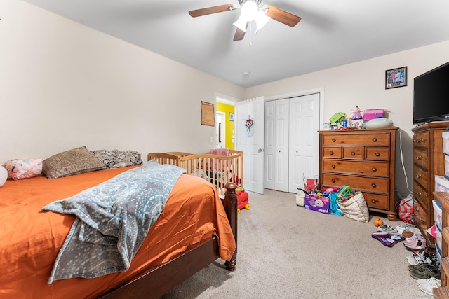 bedroom with ceiling fan, carpet flooring, and a closet