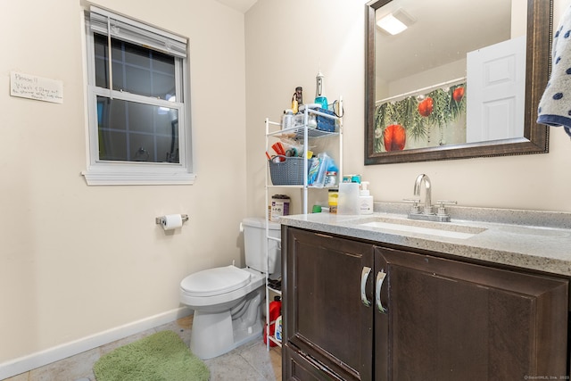 bathroom featuring vanity, tile patterned flooring, and toilet