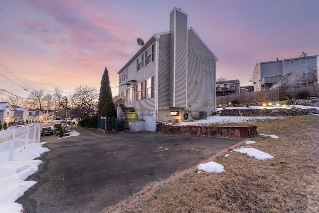 property exterior at dusk with central air condition unit