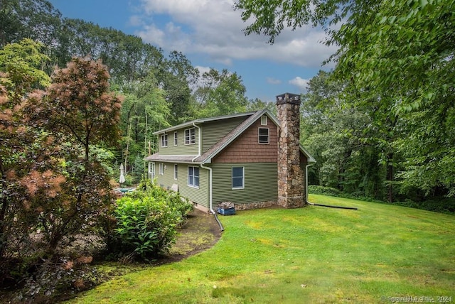 view of property exterior with a lawn