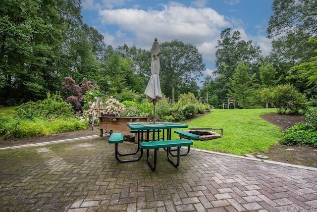 surrounding community featuring a lawn and a patio