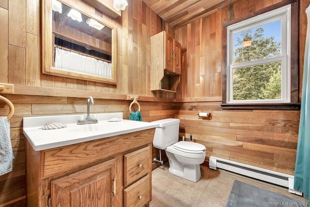 bathroom featuring vanity, tile patterned floors, wooden walls, toilet, and baseboard heating