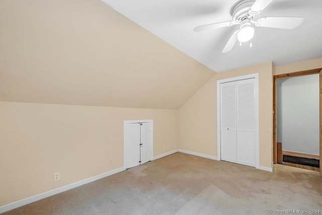 additional living space featuring ceiling fan, light colored carpet, and vaulted ceiling