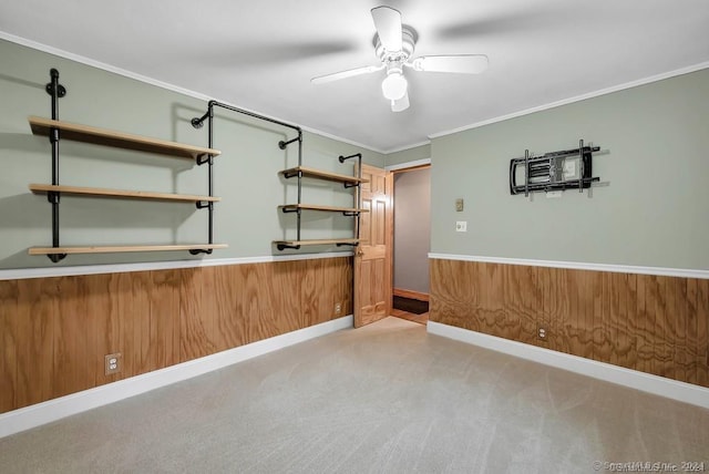 interior space featuring wooden walls, ceiling fan, and crown molding