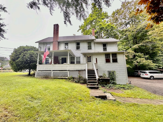 back of house with a lawn