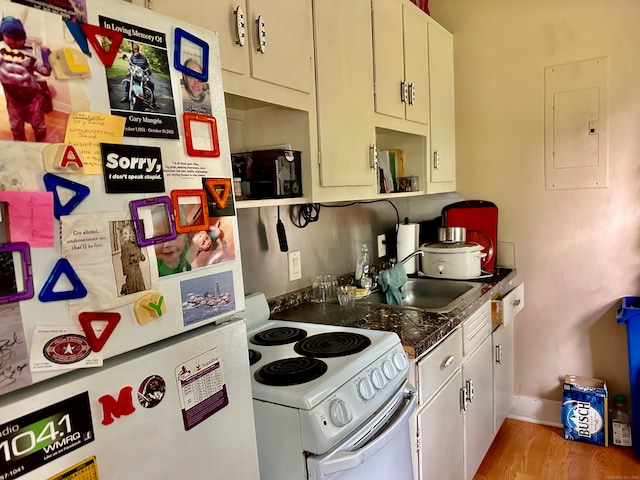 kitchen featuring sink, light hardwood / wood-style floors, white appliances, and electric panel