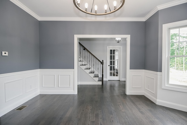 interior space with dark hardwood / wood-style floors, crown molding, and an inviting chandelier