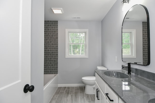 full bathroom with wood-type flooring, vanity, toilet, and tub / shower combination