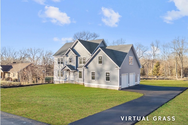 view of front of property featuring a garage and a front lawn