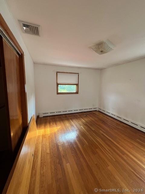 spare room with wood-type flooring