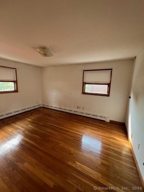 empty room with dark hardwood / wood-style floors