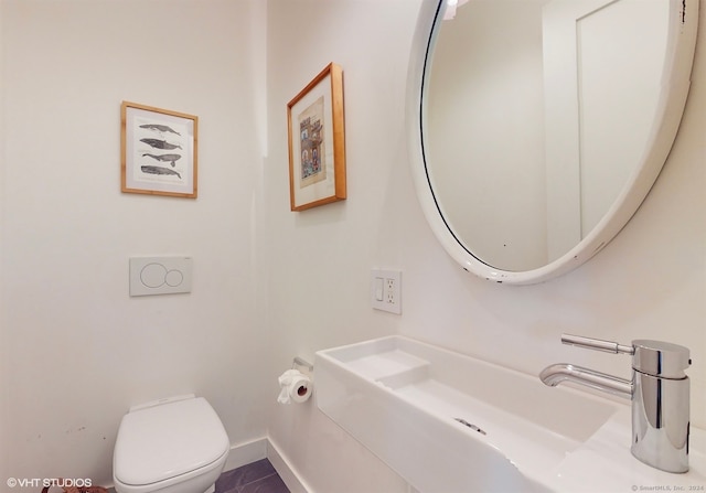 bathroom with tile patterned floors, sink, and toilet