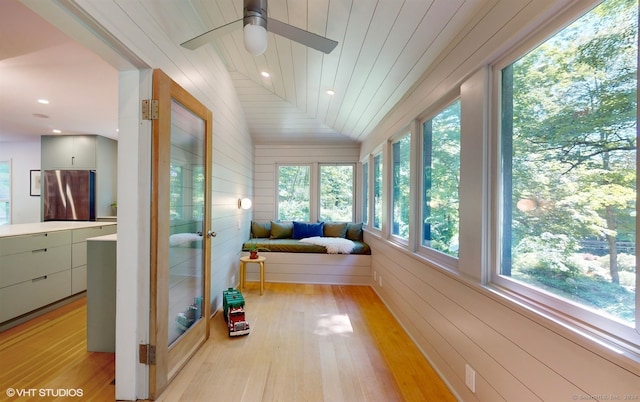 sunroom / solarium with a healthy amount of sunlight, vaulted ceiling, and wooden ceiling