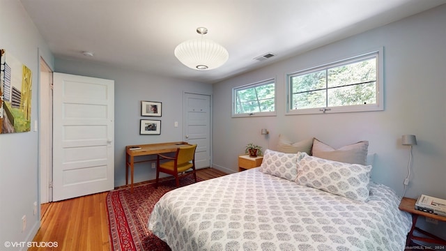 bedroom with wood-type flooring