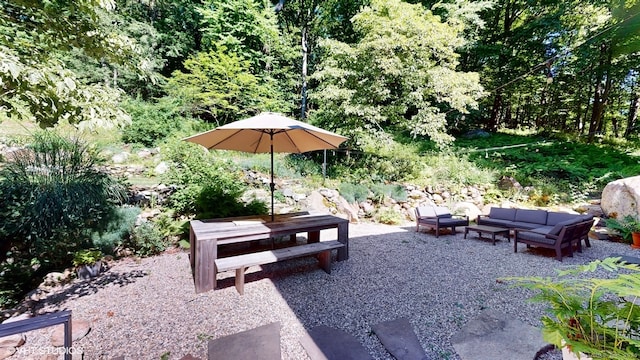 view of property's community with a patio and an outdoor living space