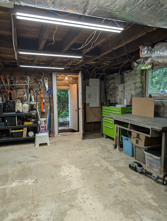 garage with electric panel and a workshop area