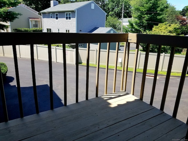 wooden deck with a residential view and fence