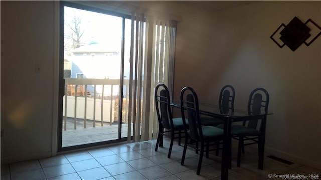 tiled dining area with a healthy amount of sunlight and visible vents