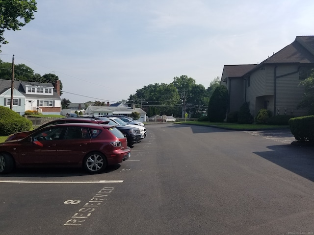 uncovered parking lot featuring a residential view