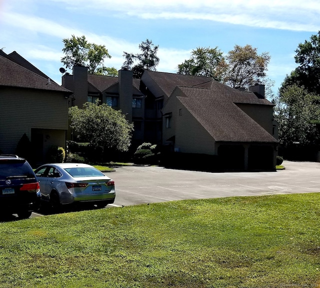 exterior space featuring a lawn and a chimney