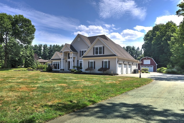 view of front of home with a front lawn and an outbuilding