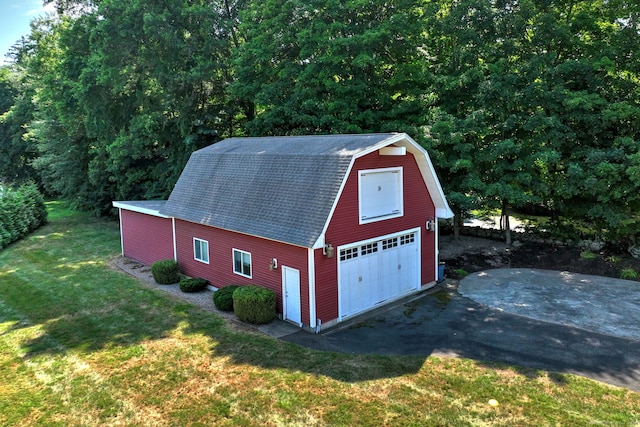 view of outbuilding with a yard