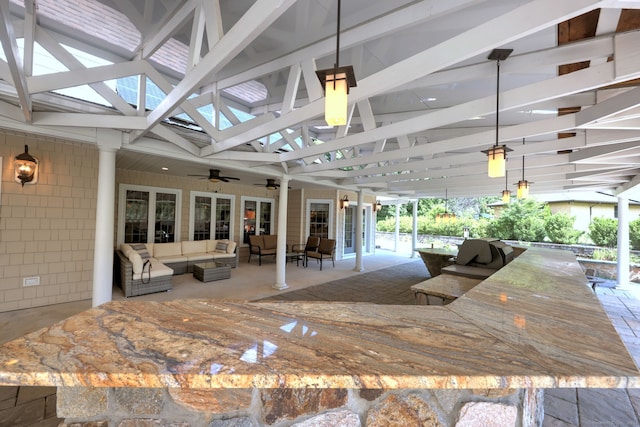 interior space featuring an outdoor hangout area and ceiling fan