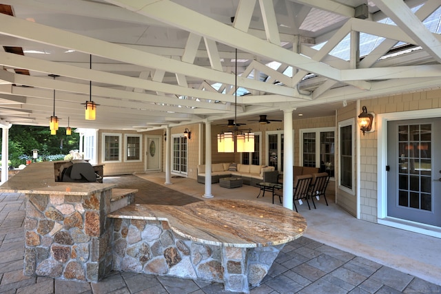 view of patio / terrace featuring outdoor lounge area, a bar, and ceiling fan