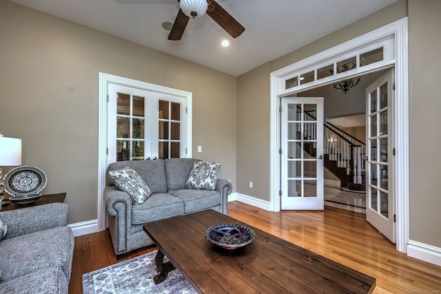 living room featuring french doors, wood-type flooring, and ceiling fan