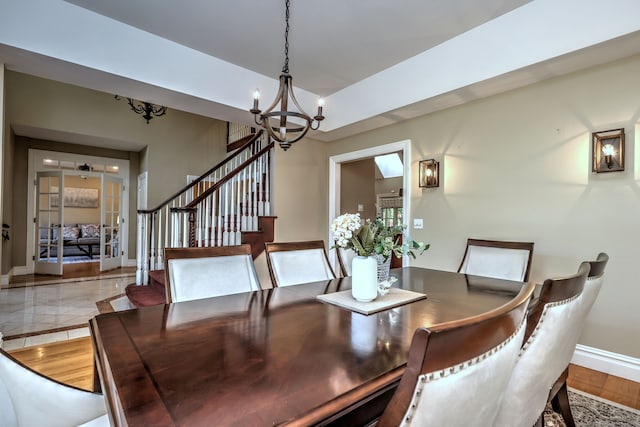 dining room featuring hardwood / wood-style floors and a chandelier