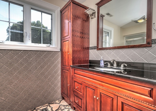 bathroom featuring vanity, backsplash, and tile patterned flooring