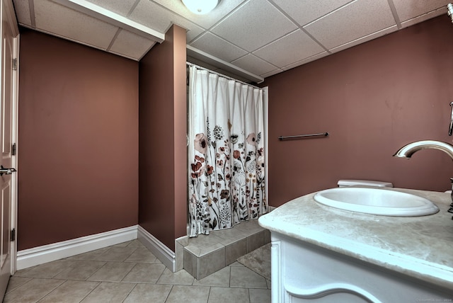 bathroom featuring tile patterned floors, a paneled ceiling, a shower with curtain, and vanity