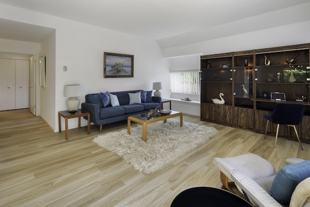 living room with lofted ceiling and light hardwood / wood-style floors