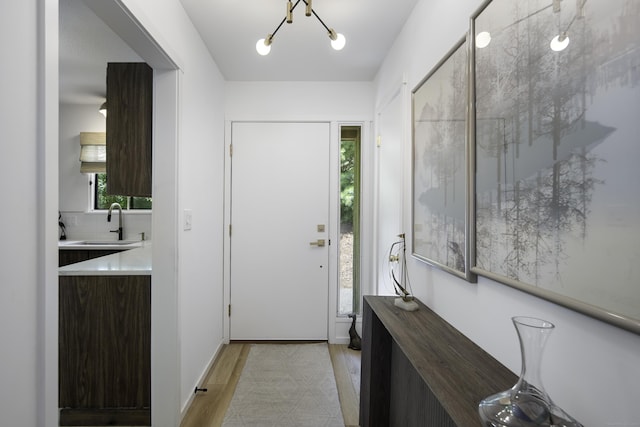 interior space with light hardwood / wood-style floors and sink