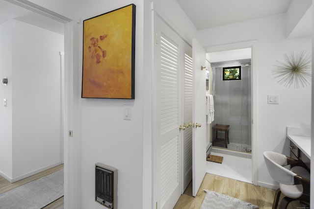 bathroom featuring heating unit and wood-type flooring