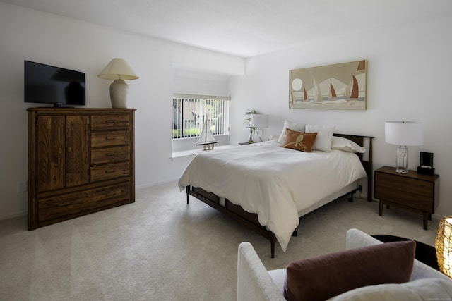 bedroom with light colored carpet