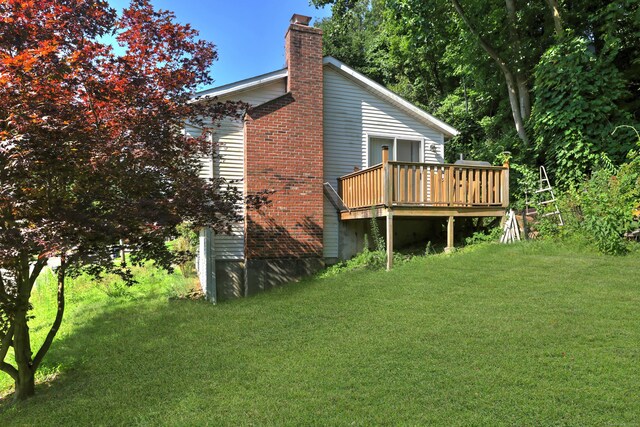 exterior space featuring a lawn and a wooden deck