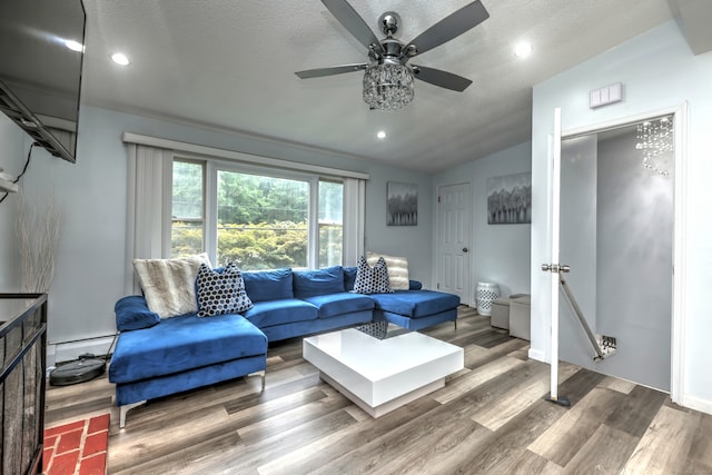 living room featuring a textured ceiling, ceiling fan, hardwood / wood-style floors, a baseboard radiator, and vaulted ceiling