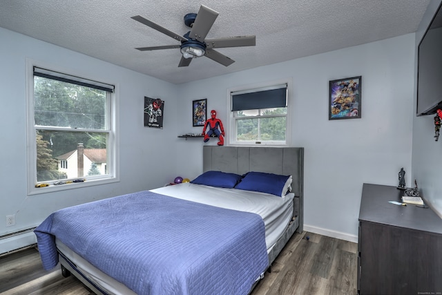 bedroom featuring dark wood-type flooring, a textured ceiling, and ceiling fan